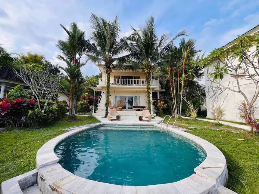 Bloom Villa and its pool among the palms